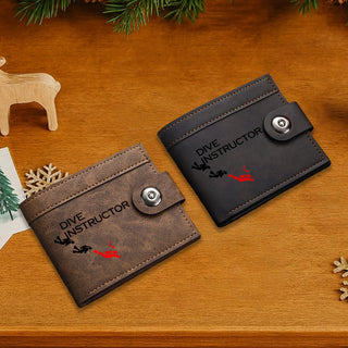 Two leather wallets with 'Dive Instructor' text on a wooden surface.