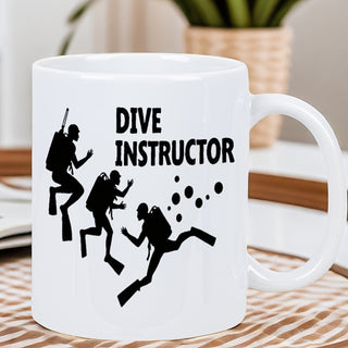White mug with 'Dive Instructor' text and diving figures on a wooden surface.